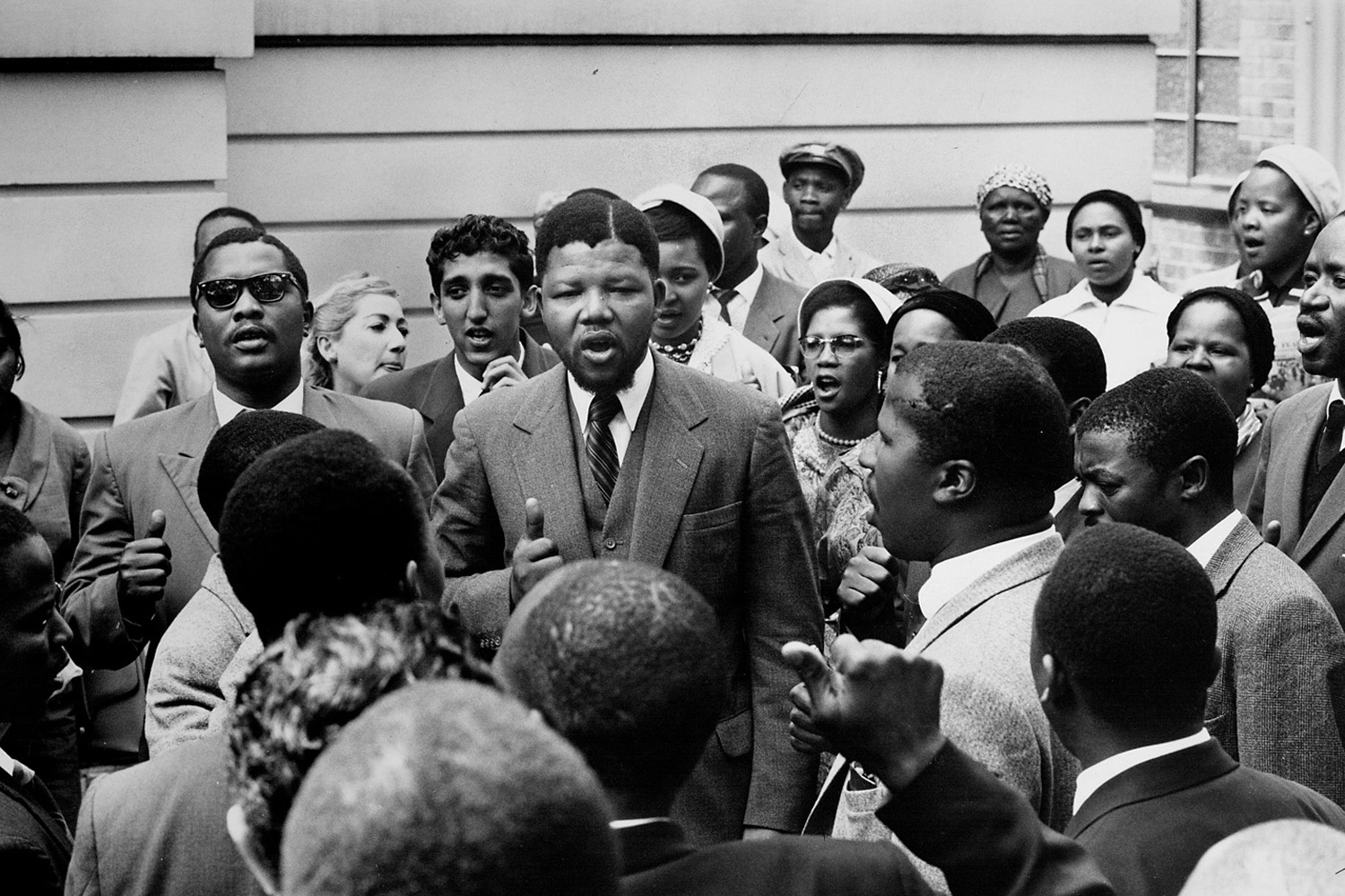 Nelson Mandela, center, stands amid a gathering of other co-defendants during the Treason Trial.
