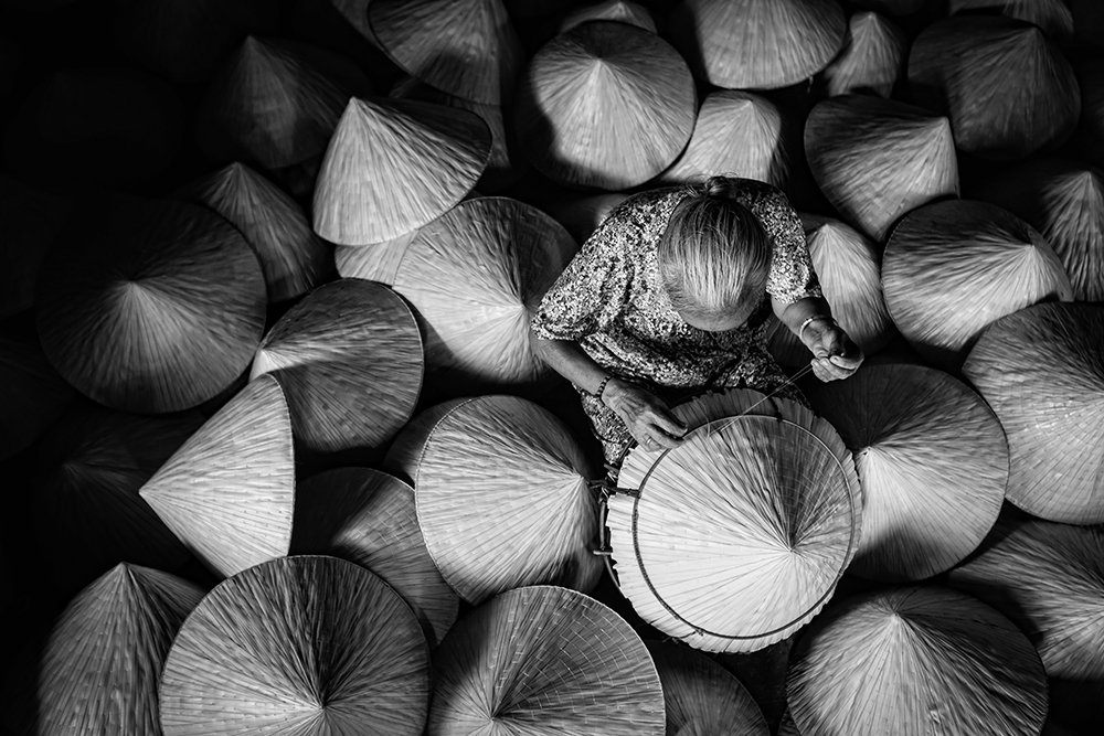 3. conical hat maker old women by JetHuynh / Picfair