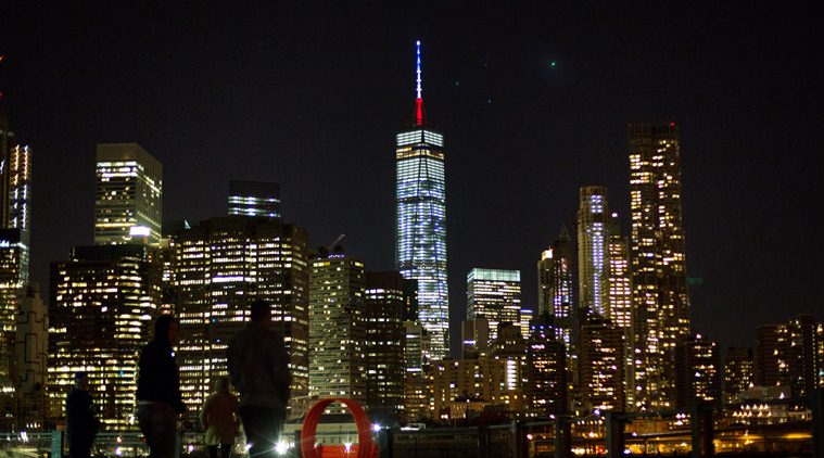 The One World Trade Center spire is lit blue, white and red after New York Gov. Andrew Cuomo announced the lighting in honor of dozens killed in the Paris attacks Friday, Nov. 13, 2015, in New York. French officials say several dozen people have been killed in shootings and explosions at a theater, restaurant and elsewhere in Paris. (AP Photo/Kevin Hagen)