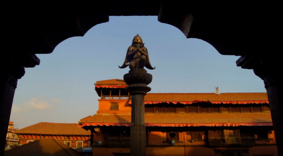 Statue of Garuda (Eagle, large mythical bird) doing Namaste in Patan Durbar Square, view from Krishna Mandir main door, Nepal