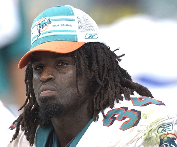 Miami Dolphins running back Ricky Williams checks play September 7, 2003 at Pro Player Stadium, Miami, Florida. The Houston Texans defeated the Dolphins 21 - 20 to open the NFL football season. (Photo by Al Messerschmidt/Getty Images)