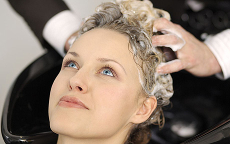 Woman having hair washed at beauty salon
