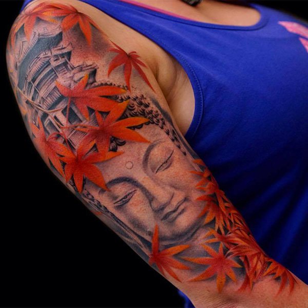 This tattoo could literally look relaxing and that could be because maple leaves are generally associated with relaxation and reservation. The red color of the maple goes with the black and white details of Buddha’s face.