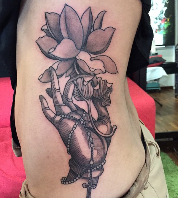 The hand of Buddha holding a lotus flower is a different one yet another alternative to Buddha and lotus designs. It’s not of the norm compared to the other designs so you may want to get this design. It’s a side tattoo so you can decide on how big it would be.