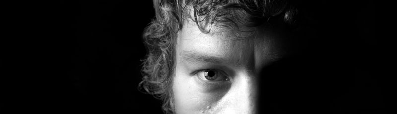 man-with-half-face-on-light