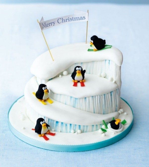 A really cute and comical Christmas cake. The cake is filled with cute little penguins on colorful sleds as they happily play around the ice celebrating a cold but fun Christmas.
