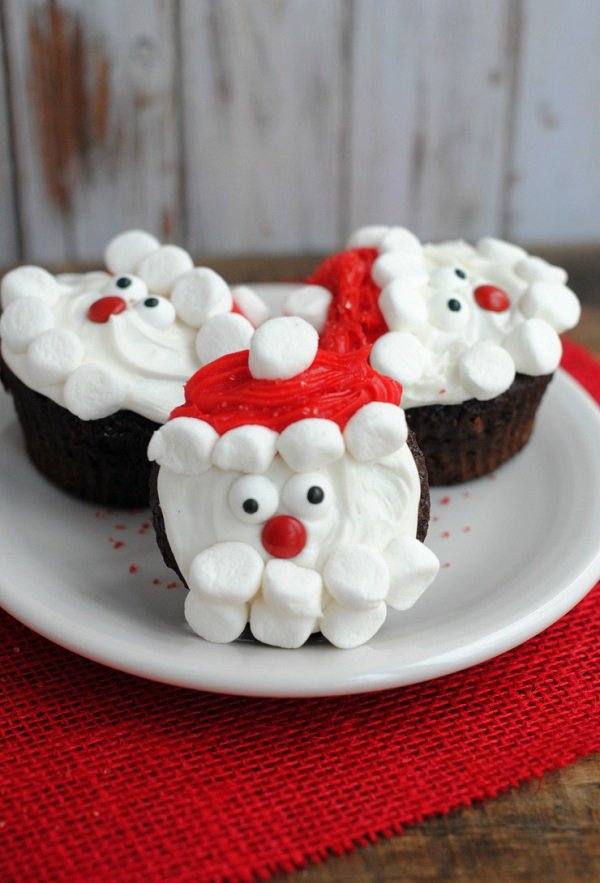 Santa inspired Christmas cupcake. The chocolate cupcakes are designed to have Santa’s cartoon face on top with the use of red and white icing.
